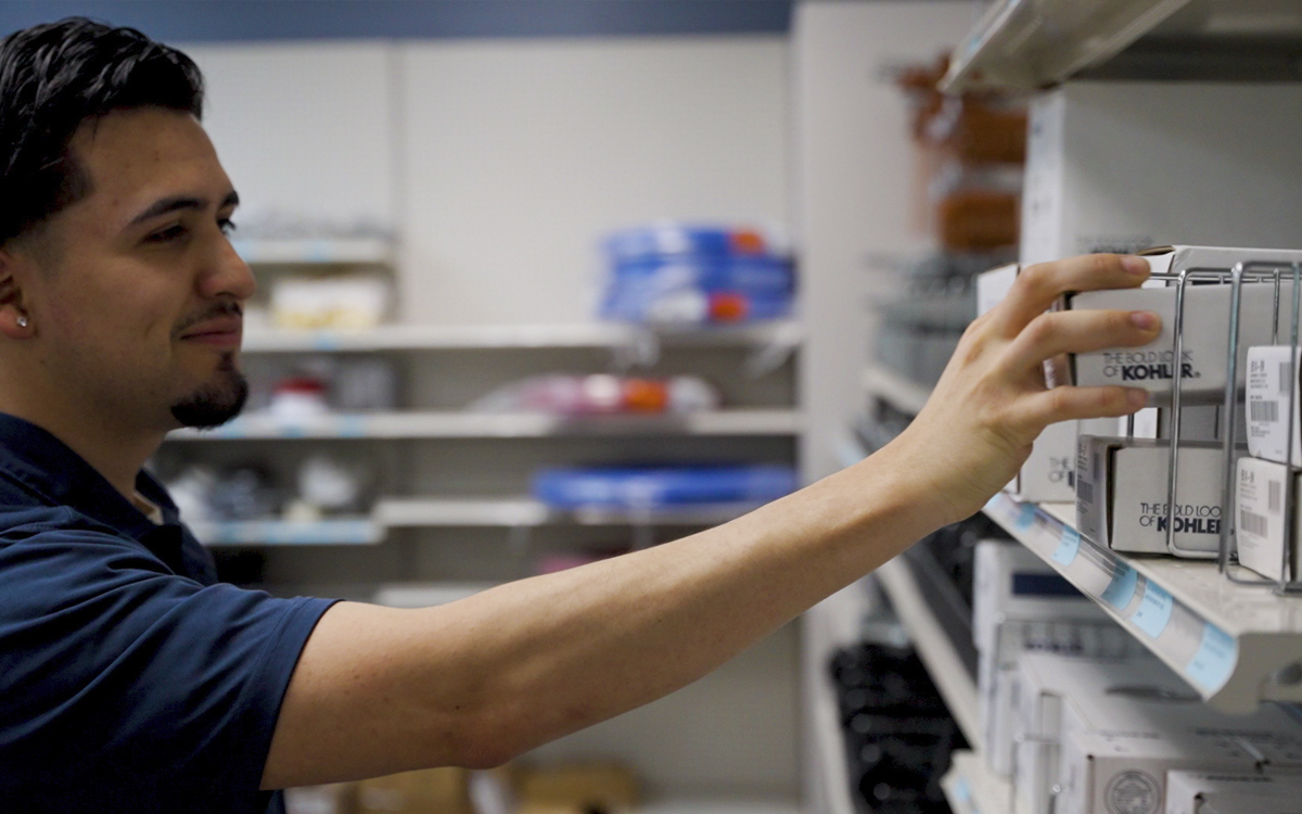 image of a worker stocking a trade counter